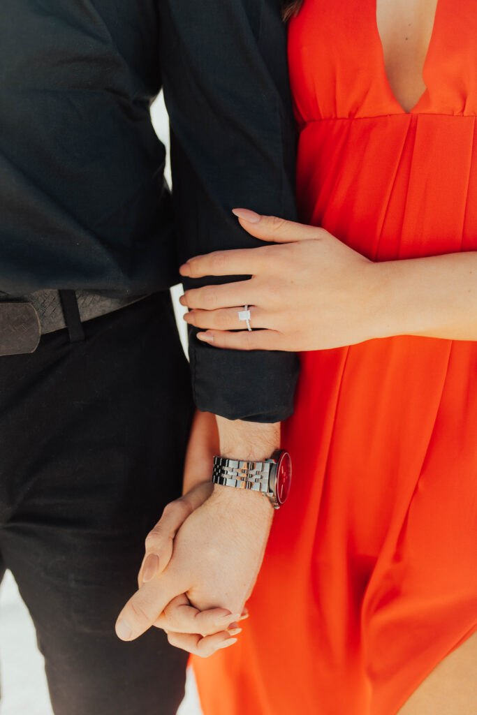 detail photo of bride-to-be's emerald diamond cut engagement ring at bonneville salt flats engagement session