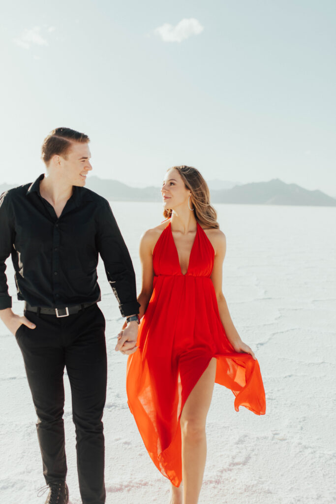 Cinematic portrait of bride in red dress at Bonneville Salt Flats.