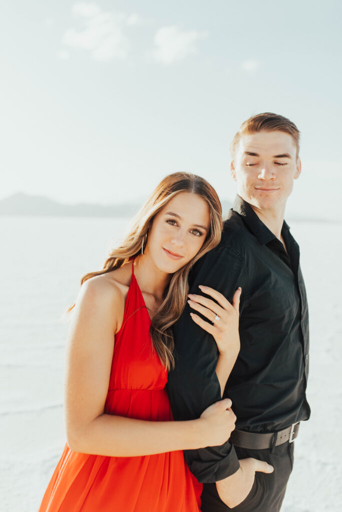 Editorial-style portrait of bride in red dress at Bonneville Salt Flats.
