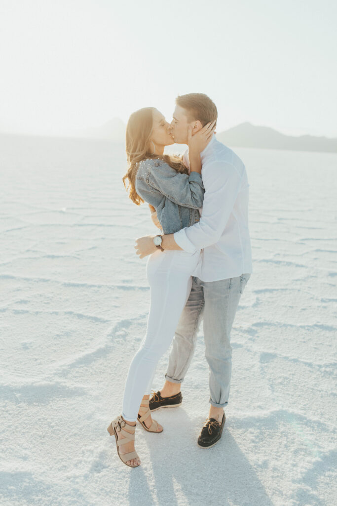 Backlit Salt Flats engagement photo with bride in custom mrs. denim jacket.