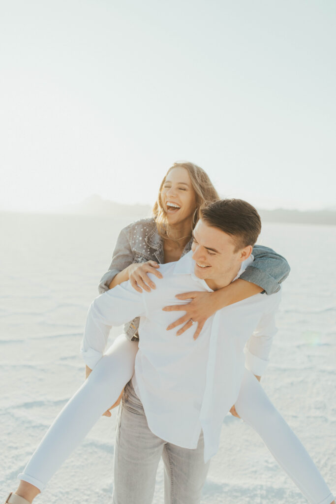 Couple celebrating their love during destination Salt Flats engagements at golden hour.
