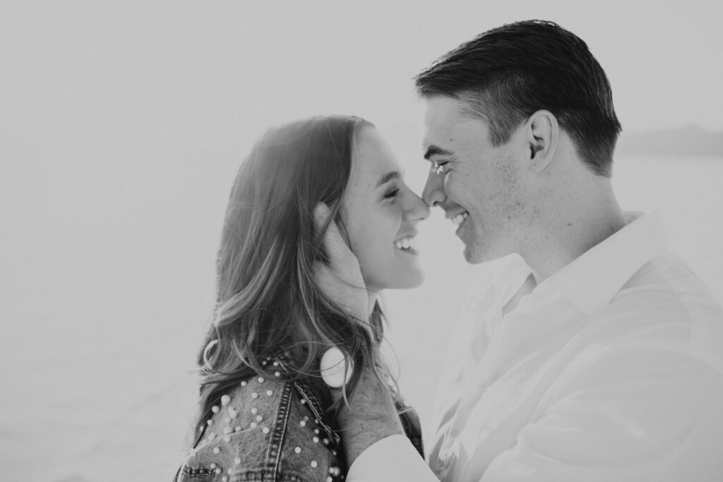 Black and White close-up photo of groom holding his bride's face