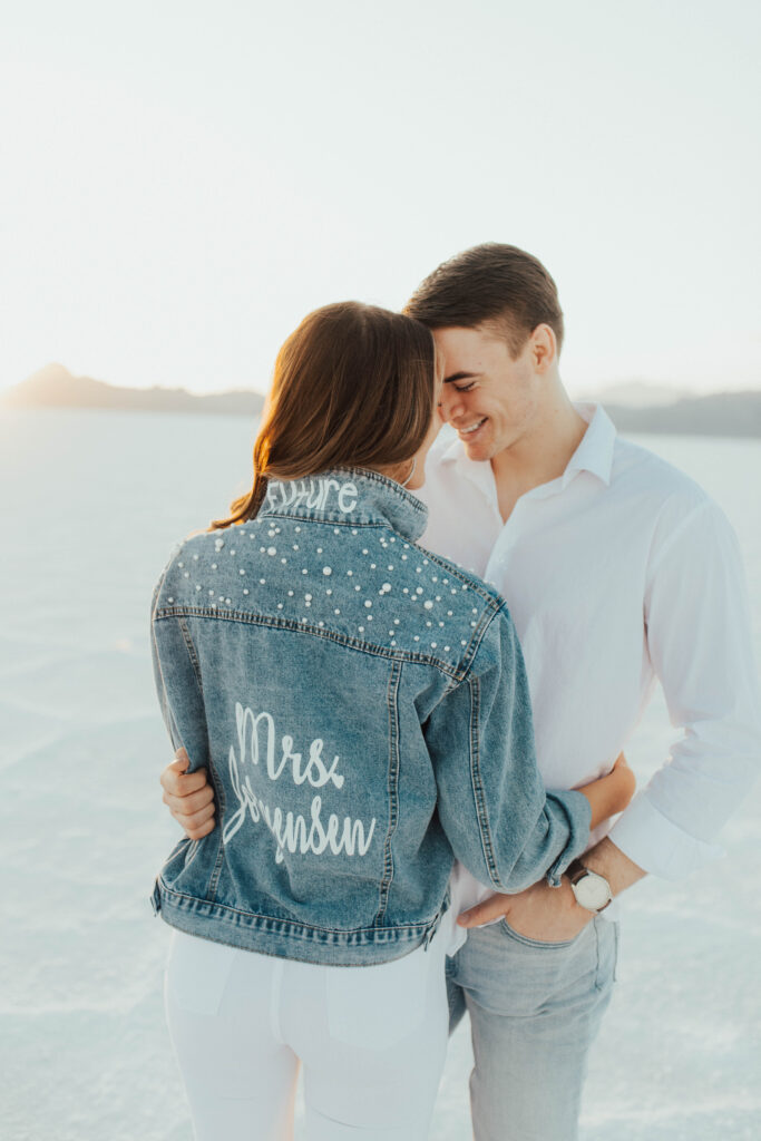 Bride turning to show custom denim jacket during Salt Flats portraits.