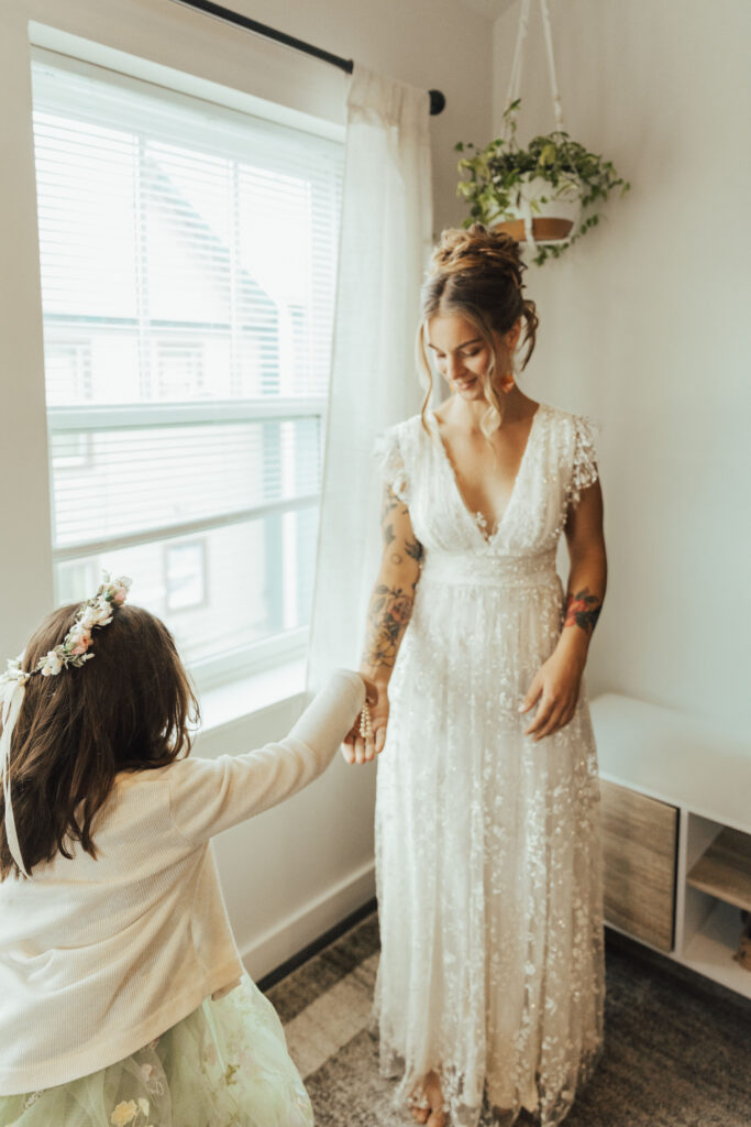 Bride getting ready with her flower girl before a Crested Butte mountain wedding