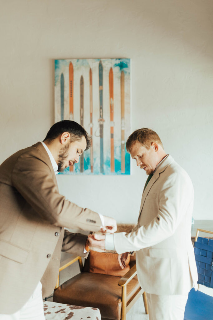 Best man helping the groom get ready during a Crested Butte wedding morning